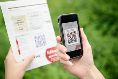 Scanning advertising with QR code on mobile smart phone.