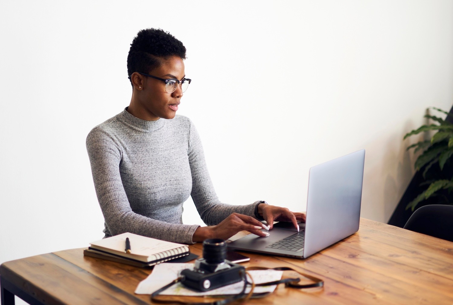 Attractive Afro American business woman using laptop computer.