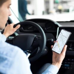 Man looking at map app while driving.