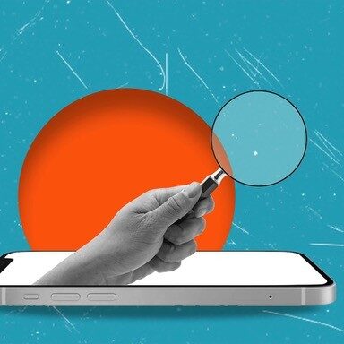 A hand with a magnifying glass sticking out of a smartphone screen.