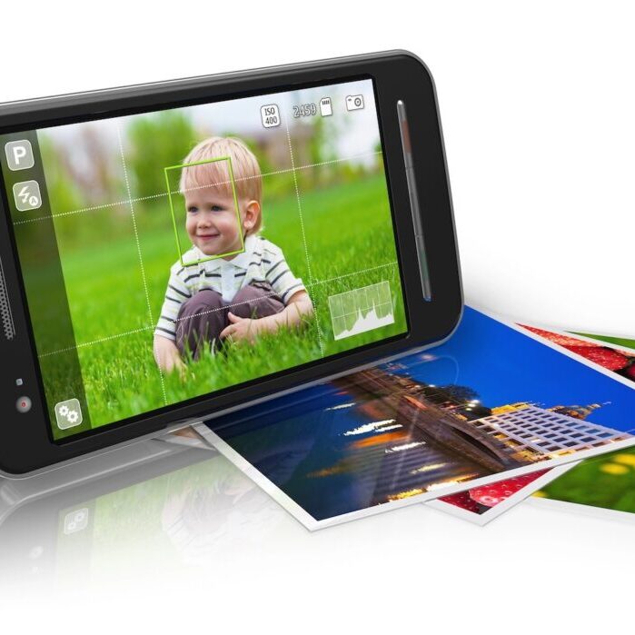 Touchscreen smartphone in camera mode and set of photos isolated on white reflective background.
