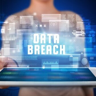Person holding a tablet with data breach language.