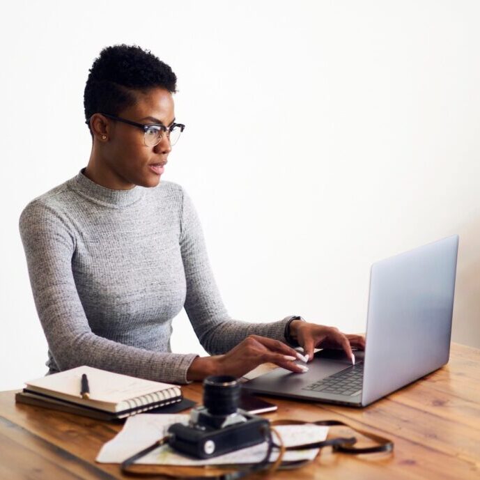 Attractive Afro American business woman using laptop computer.